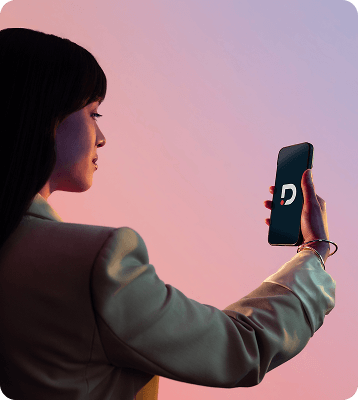 Modern image of woman looking at a mobile phone which is showing the Dragonpass logo